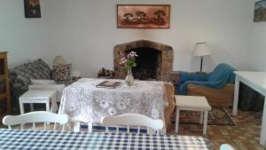 a living room with a table with a vase of flowers on it at Paz Cottage in Juliasdale