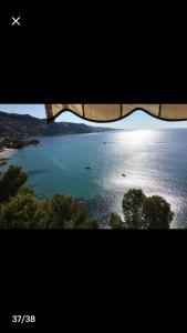 a view of a large body of water with trees at Appartamento Villa Panorama in Mortola Inferiore