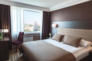 Postel nebo postele na pokoji v ubytování Premier Hotel Rus