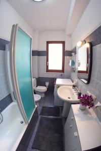a bathroom with a sink and a toilet and a shower at Villa Fraele in Acireale