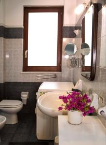 a bathroom with a sink and a toilet and a window at Villa Fraele in Acireale +102 photos