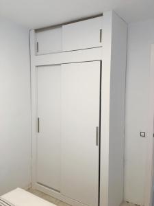 a white closet with a sliding door in a room at Aiguaneu Sa Carbonera in Blanes