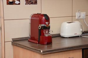 a red mixer sitting on a counter next to a toaster at Masi Felső Apartman in Pécs