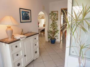 a room with a white dresser with a lamp on it at Holiday home with private pool in Villedaigne