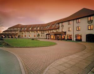 a large building with a brick walkway in front of it at The Peninsula Hotel in Vale