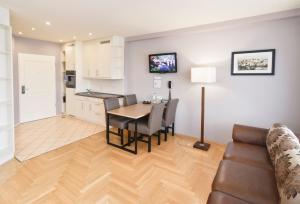 a kitchen and dining room with a table and a couch at AMC Apartments Ku'damm & Bundesallee in Berlin