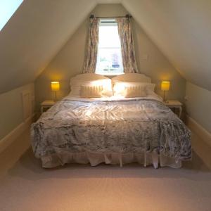 a bedroom with a large bed with a window at Eydon B&B in Daventry