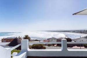a view of the beach from the balcony of a house at 16 Mile View in Yzerfontein