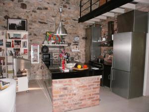 a kitchen with a brick wall and a refrigerator at Joanna in Stavroupoli +33 photos