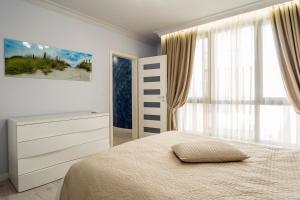 מיטה או מיטות בחדר ב-Vacation Apartment