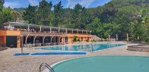 a large swimming pool in front of a building at Appartamento Vista Mare - Spriano in Rio Marina