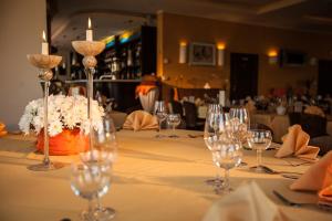 a table with wine glasses and candles on it at Villa del Mar in Niechorze +112 photos