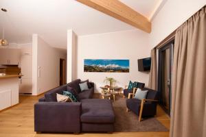 a living room with two couches and a table at Kitzlife Apartements in Kitzbühel