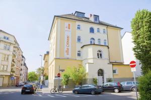 a building with a sign on the side of it at BIO-Hotel Villa Orange in Frankfurt