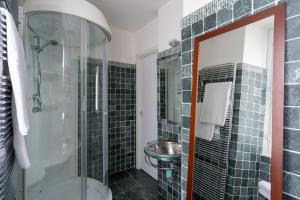 a bathroom with a glass shower and a sink at Lovely Apartment Overlooking Lake Como by Rent All Como in Carate Urio