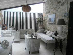 a living room with a couch and chairs at Joanna in Stavroupoli