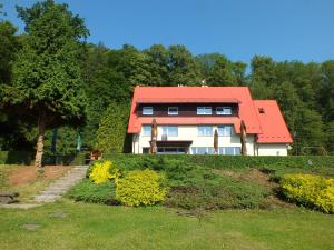 a house with a red roof on a hill at Hotel Salaš in Šenov u Nového Jičína