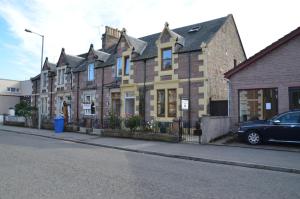 a building with a car parked in front of it at The Quaich B&B in Inverness