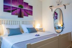 a bedroom with a bed and a large mirror at Apartment Placido Krk in Krk