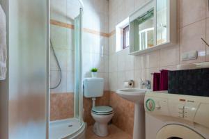 a bathroom with a toilet and a shower and a sink at Apartment Placido Krk in Krk +26 photos