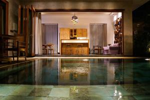 a house with a swimming pool in a living room at deLodtunduh Villa 2 in Ubud