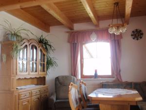 a dining room with a table and a window at Rettlhof in Sankt Peter am Kammersberg
