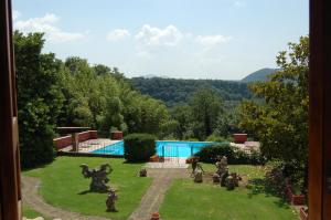 a garden with statues and a swimming pool at Agriturismo Castro in Ischia di Castro