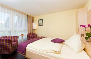 Ένα ή περισσότερα κρεβάτια σε δωμάτιο στο Hotel Alexander