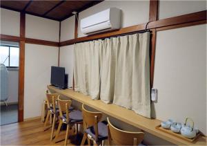 a room with a room with chairs and a window at Kiki HouseT --Self Check-in -- Room Number & Password is in the following email in Tokyo