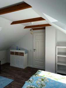 a attic room with a bed and a white door at Adlerhorst in Königstein an der Elbe