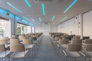 an empty lecture room with chairs and a whiteboard at Room Mate Oscar, Madrid in Madrid