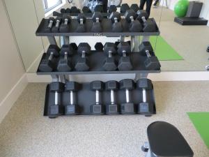 a display of dumbbells on a shelf in an office at The Alexander, A Dolce Hotel in Indianapolis