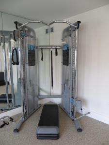 a gym with a black treadmill in a room at The Alexander, A Dolce Hotel in Indianapolis