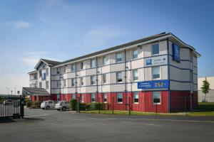 a large apartment building with a red and white at ibis budget Saint Lô in Saint Lo +43 photos