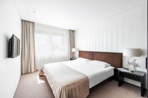 Postel nebo postele na pokoji v ubytování Amberton Hotel Klaipeda