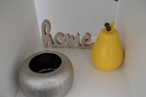 a sign that says karma next to a yellow vase at Apart By Jo in Saint-Germain-en-Laye