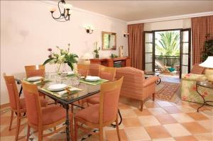a dining room with a table and chairs at Pine Cliffs Village & Golf Suites in Albufeira