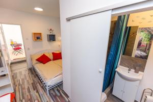 a bathroom with a couch and a sink in a room at Center Rooms with terrace in Rijeka