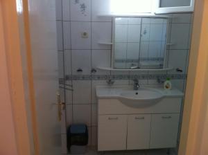 a bathroom with a sink and a mirror at Apartments Jelen in Dubrovnik +38 photos