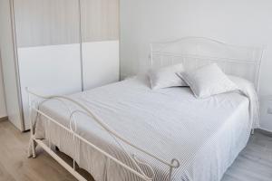 a white bed with two white pillows on it at S186 - Sirolo, meraviglioso cielo-terra in centro storico in Sirolo