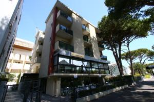 an apartment building in the middle of a street at Hotel Monica in Riccione