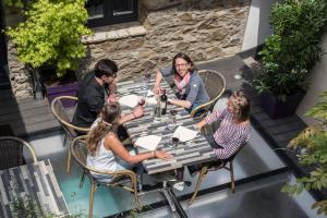 a group of people sitting at a table at Hôtel Restaurant Corto Maltese in Le Palais
