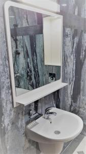 a bathroom with a white sink and a mirror at Хотел "АВЕНЮ" in Stara Zagora +24 photos