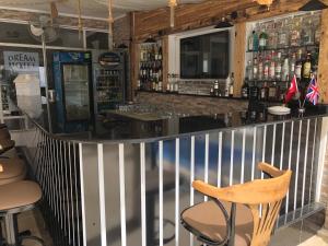 a bar in a restaurant with a counter and a chair at Kalkan Dream Hotel in Kalkan