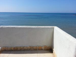 a concrete wall with the ocean in the background at Villa Fiorella in Sciacca
