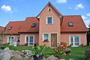 a pink house with red roof at Relax Kruklanki in Kruklanki