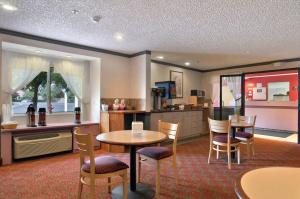 a kitchen and dining room with a table and chairs at Americas Best Value Inn - East Syracuse in East Syracuse