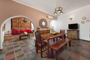 a living room with a table and a couch at Villa Anastasia in Líndos