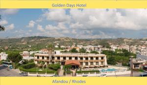 a large building in a city with a mountain at Golden days in Afantou