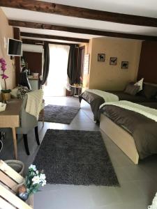 a bedroom with two beds and a living room with rugs at La Beverita in Ventimiglia